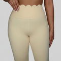 Professional beige scalloped leggings on grey background
